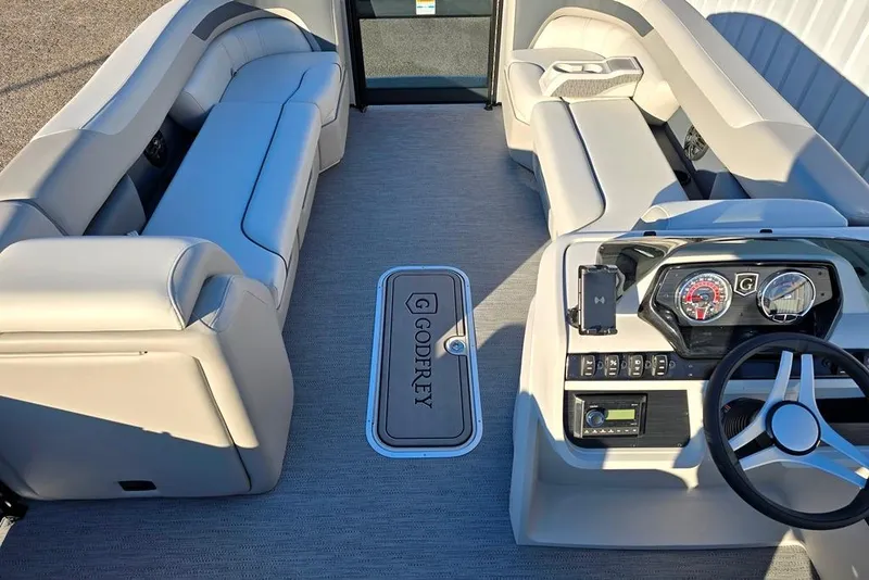 Slide: The Image of Interior of 2026 Sweetwater 2286 SBC boat with plush seating and modern dashboard. - 3