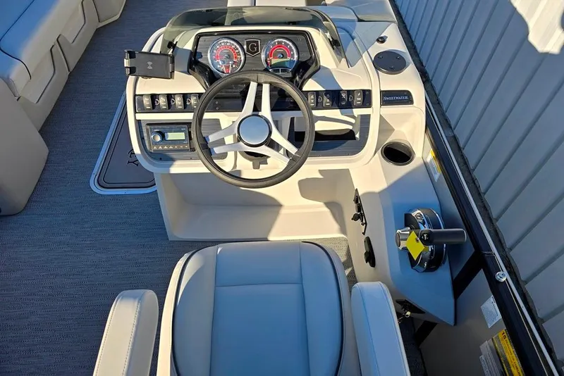Slide: The Image of 2026 Godfrey Sweetwater 2286 SBC boat interior with modern helm and comfortable seating. - 5