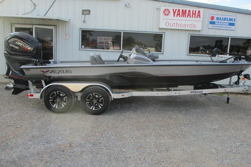The Image of 2026 Vexus AVX2080 boat on trailer, parked outside Yamaha and Suzuki Marine dealership. - 0
