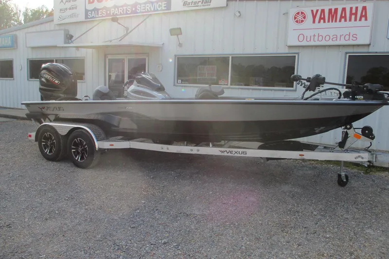 Slide: The Image of 2026 Vexus AVX2080 boat on trailer outside dealership with Yamaha signage. - 1
