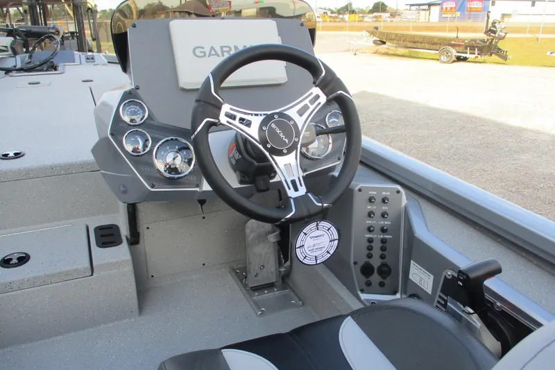 Slide: The Image of 2026 Vexus AVX2080 boat dashboard with Garmin display and steering wheel. - 12