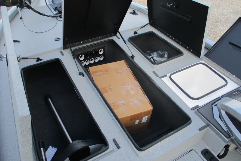 Slide: The Image of 2026 Vexus AVX2080 boat storage compartments with cardboard box and equipment. - 18