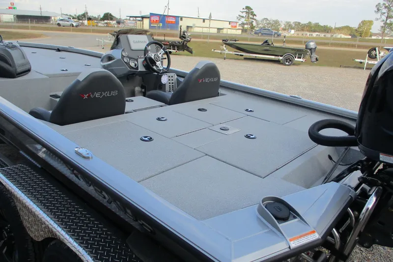 Slide: The Image of 2026 Vexus AVX2080 boat interior with steering wheel and seating, parked outdoors. - 21