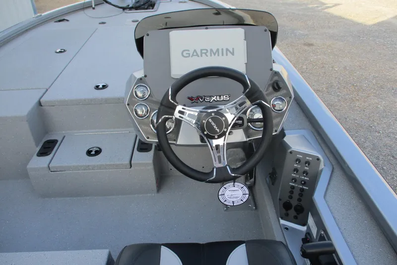 Slide: The Image of 2026 Vexus AVX2080 boat dashboard with Garmin display and steering wheel. - 22