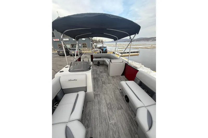 Slide: The Image of 2026 Bentley Pontoons Legacy 200 Cruise XL with spacious seating and canopy on a dock. - 10