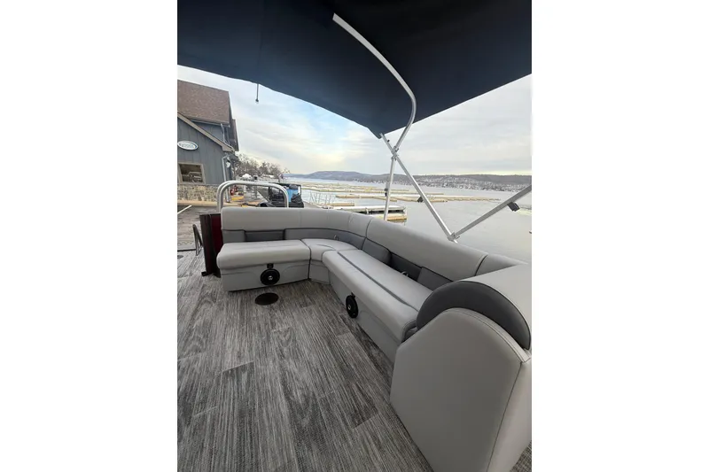 Slide: The Image of 2026 Bentley Pontoons Legacy 200 Cruise XL interior with gray seating and waterfront view. - 13