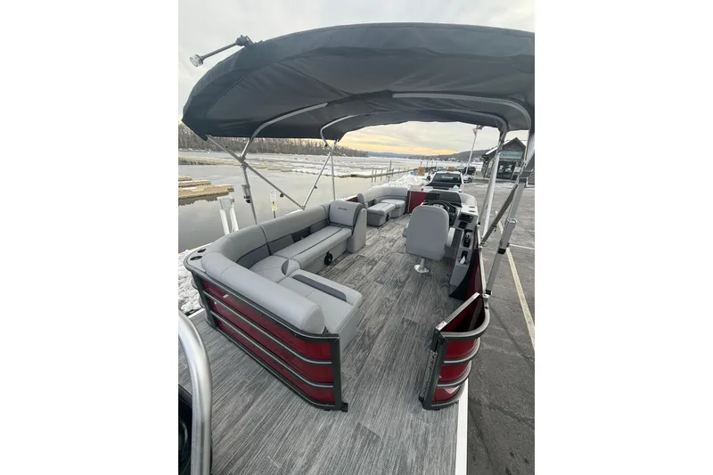 Slide: The Image of 2026 Bentley Pontoons Legacy 200 Cruise XL with spacious seating and canopy on a serene dock. - 7