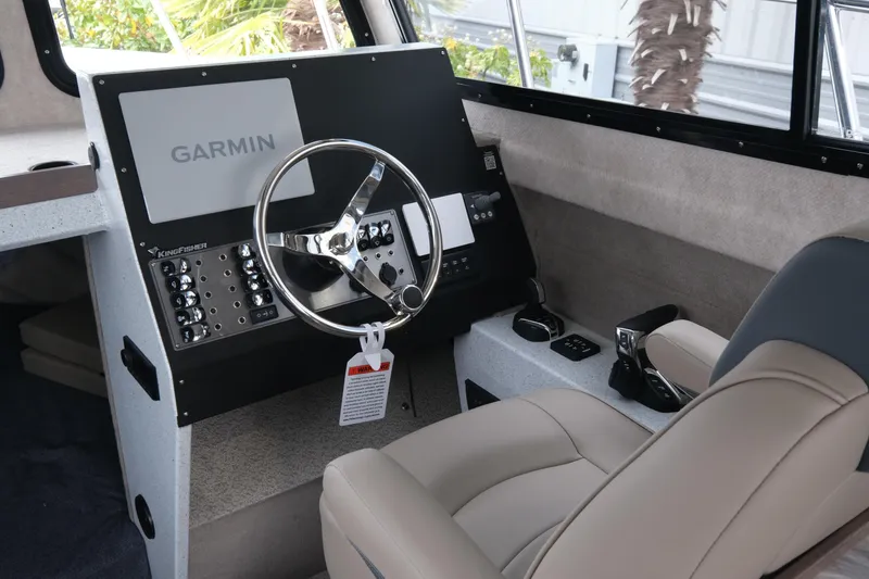 Slide: The Image of Interior of 2026 KingFisher 3025 XRS boat with Garmin navigation system and steering wheel. - 12