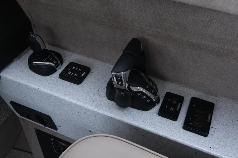 Slide: The Image of Control panel of 2026 KingFisher 3025 XRS boat with modern joystick and switches. - 14