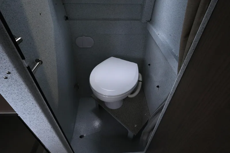 Slide: The Image of Compact bathroom in 2026 KingFisher 3025 XRS boat, featuring a modern toilet. - 21