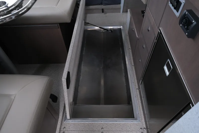 Slide: The Image of 2026 KingFisher 3025 XRS interior storage compartment with seating and cabinetry. - 23