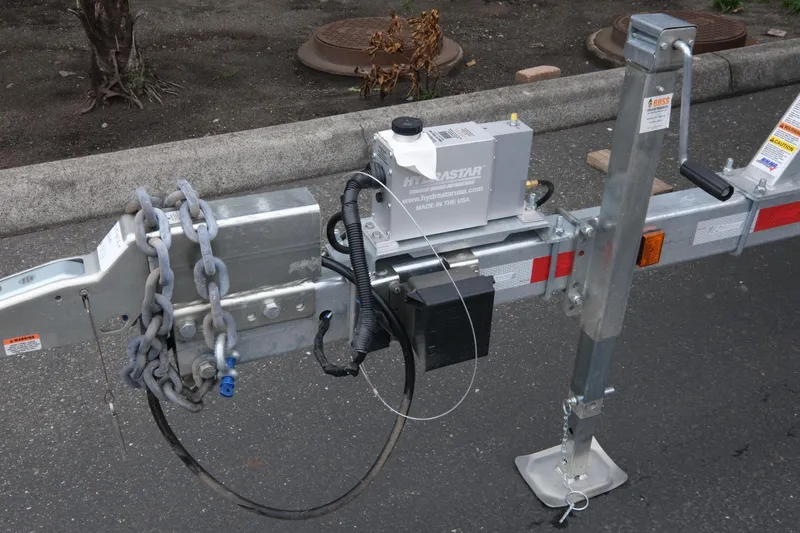 Slide: The Image of Trailer hitch with chains and hydraulic system on a 2026 KingFisher 3025 XRS. - 26