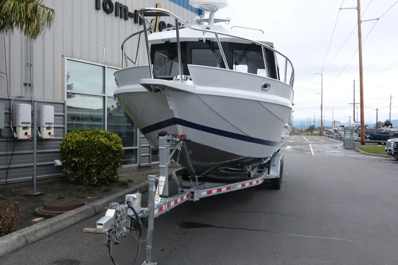 Slide: The Image of 2026 KingFisher 3025 XRS boat on trailer outside dealership. - 3