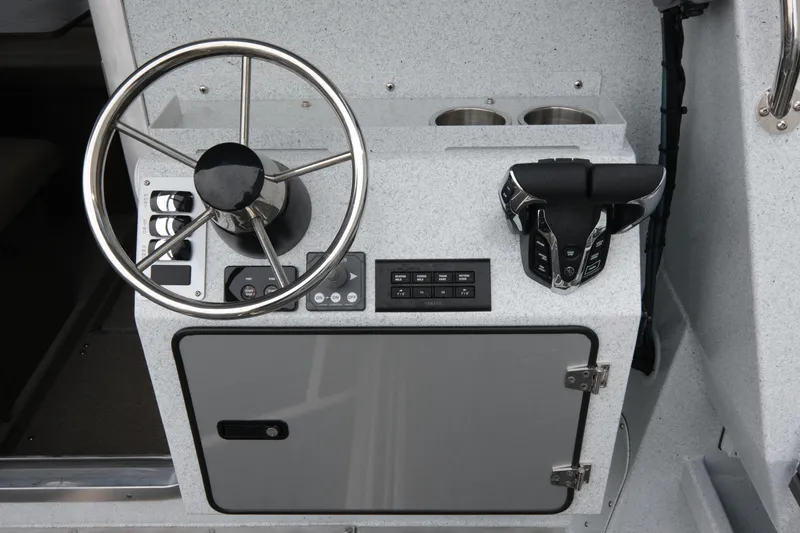 Slide: The Image of Steering console of 2026 KingFisher 3025 XRS boat with modern controls and storage. - 8