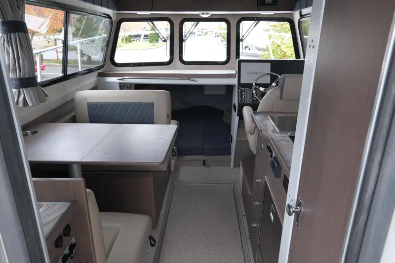 Slide: The Image of Interior of 2026 KingFisher 3025 XRS boat with seating, table, and navigation area. - 9