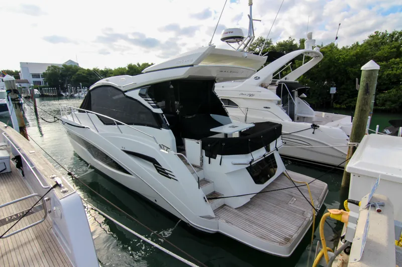 Slide: The Image of 2021 Galeon 425 HTS luxury yacht docked at marina, side view. - 10