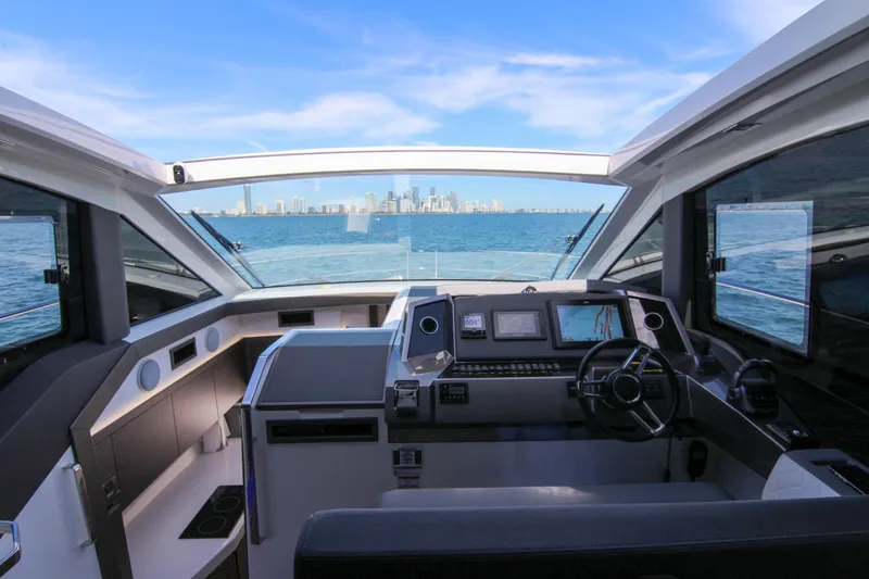 Slide: The Image of Cockpit view of 2021 Galeon 425 HTS yacht with city skyline in background. - 11