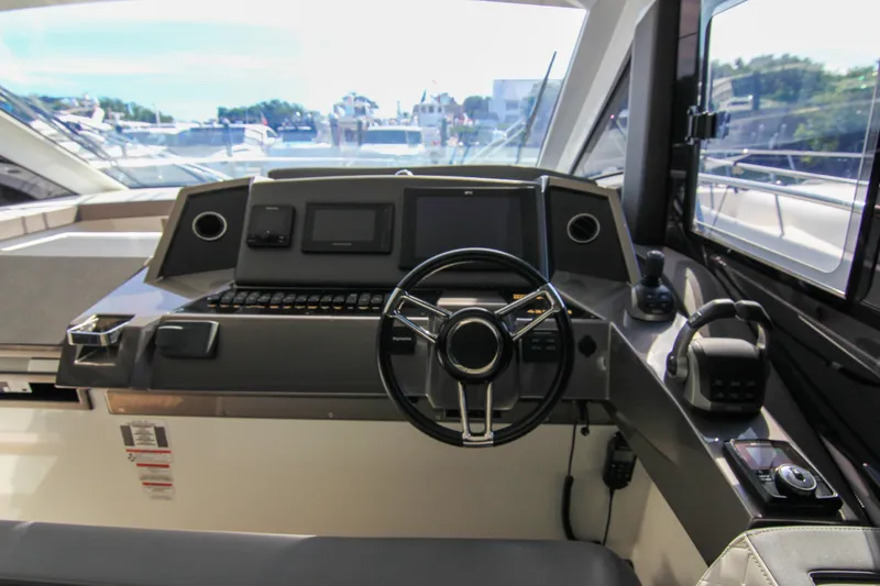 Slide: The Image of Helm of 2021 Galeon 425 HTS yacht with modern controls and navigation systems. - 12