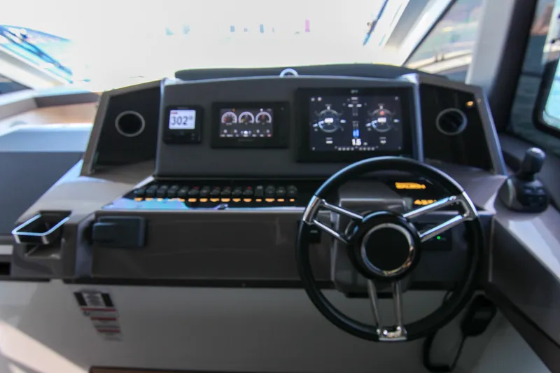 Slide: The Image of Helm of 2021 Galeon 425 HTS yacht with modern navigation displays and controls. - 13