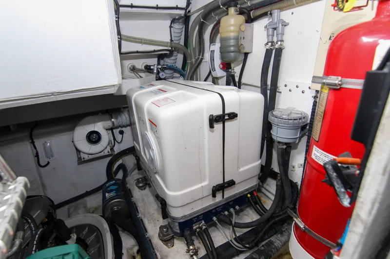 Slide: The Image of Engine room of 2021 Galeon 425 HTS yacht with equipment and fire extinguisher. - 27