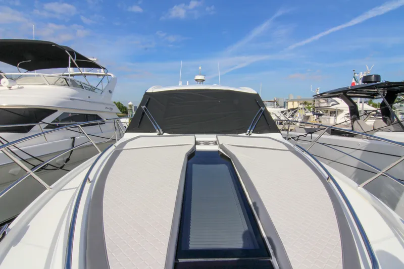 Slide: The Image of 2021 Galeon 425 HTS yacht docked, showcasing sleek design and modern features under a clear sky. - 28