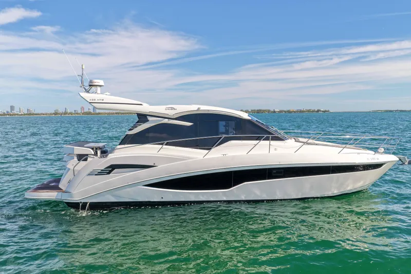 Slide: The Image of 2021 Galeon 425 HTS yacht cruising on open water under a clear blue sky. - 3