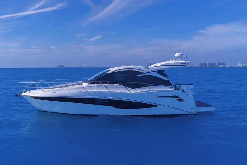 Slide: The Image of 2021 Galeon 425 HTS yacht cruising on open blue sea under clear sky. - 9