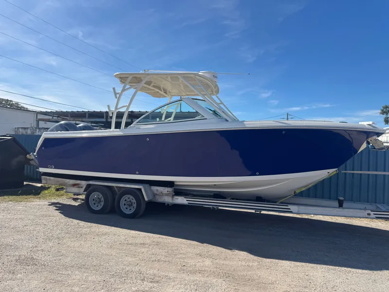 Slide: The Image of 2018 Sailfish 275 DC boat on trailer, blue hull. - 2