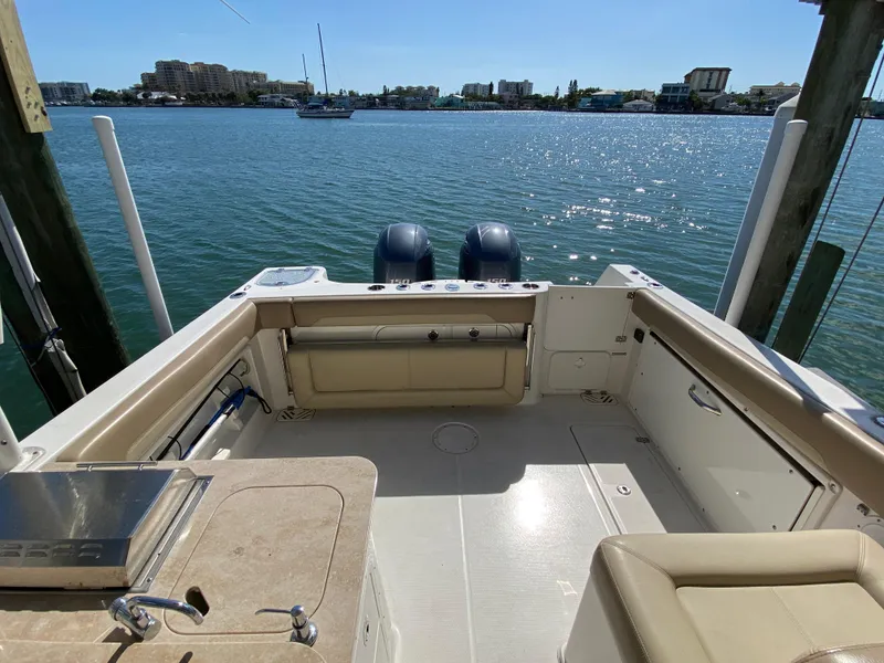 Slide: The Image of Interior view of a 2018 Sailfish 275 DC boat by the water. - 29