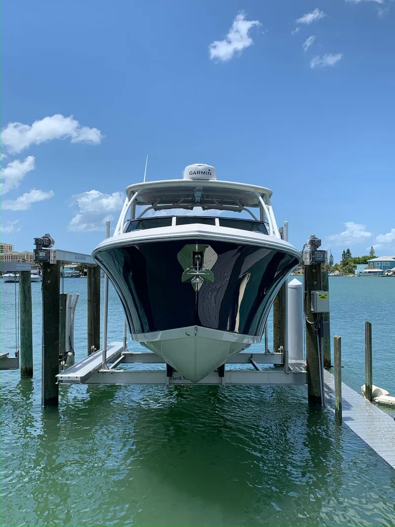 Slide: The Image of 2018 Sailfish 275 DC boat on a lift in the harbor. - 5