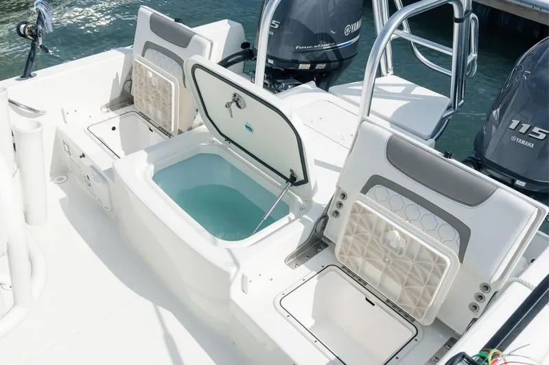 Slide: The Image of 2019 World Cat 230 CC boat with open storage compartment. - 48