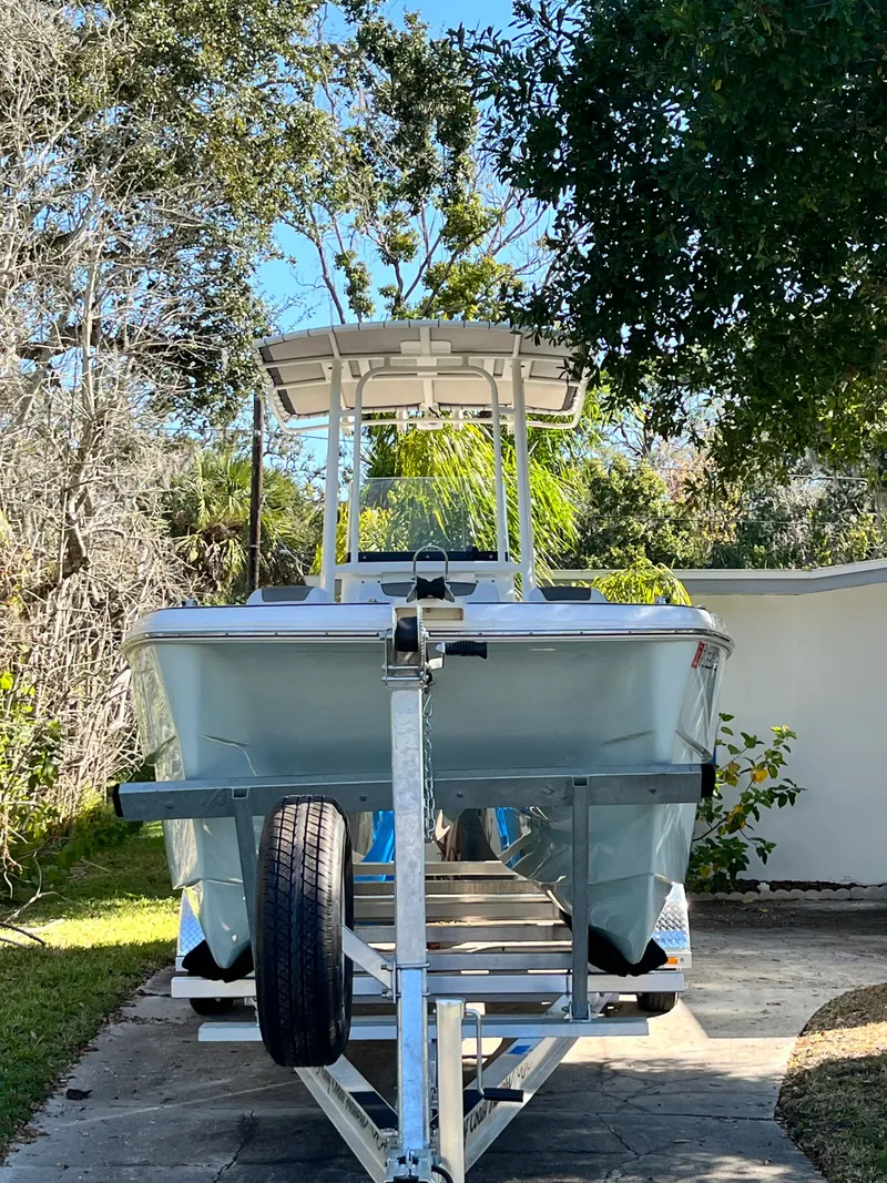 Slide: The Image of 2019 World Cat 230 CC boat on trailer outdoors. - 8