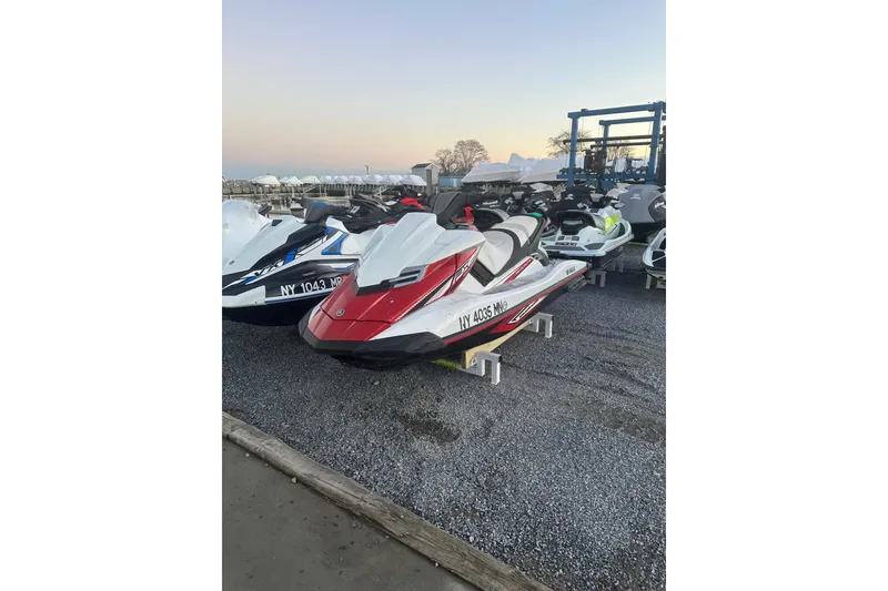 Slide: The Image of 2017 Yamaha WaveRunner FX HO in a marina setting, parked on gravel. - 3
