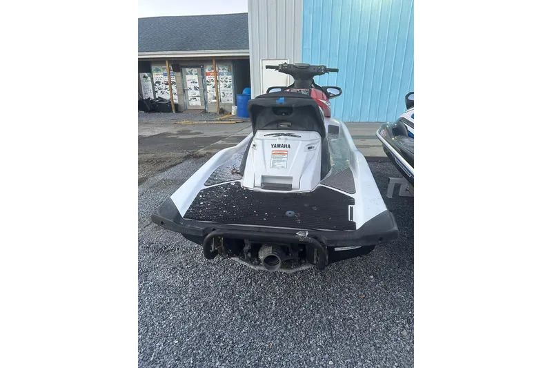 Slide: The Image of 2017 Yamaha WaveRunner FX HO jet ski parked on gravel near a blue building. - 6