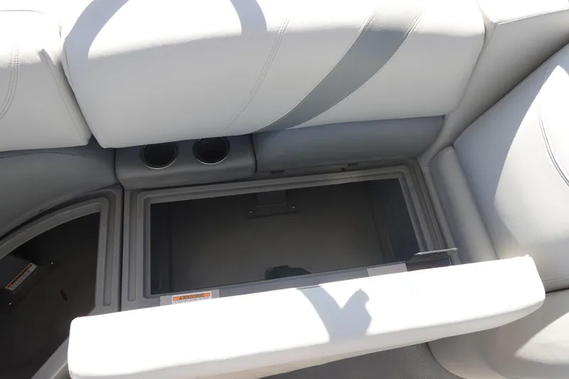 Slide: The Image of 2018 Sylvan Mirage 8522 boat seat storage compartment with cup holders, open for viewing. - 15