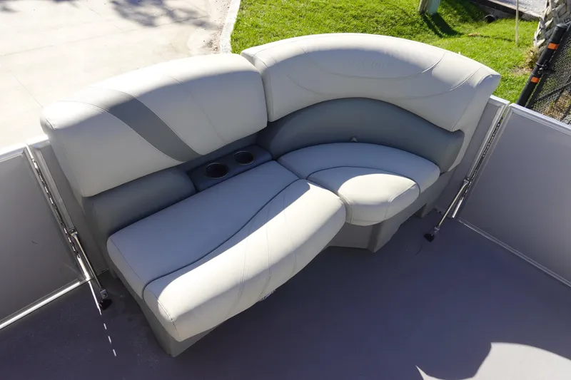 Slide: The Image of 2018 Sylvan Mirage 8522 boat seating with cup holders, featuring light gray upholstery. - 16