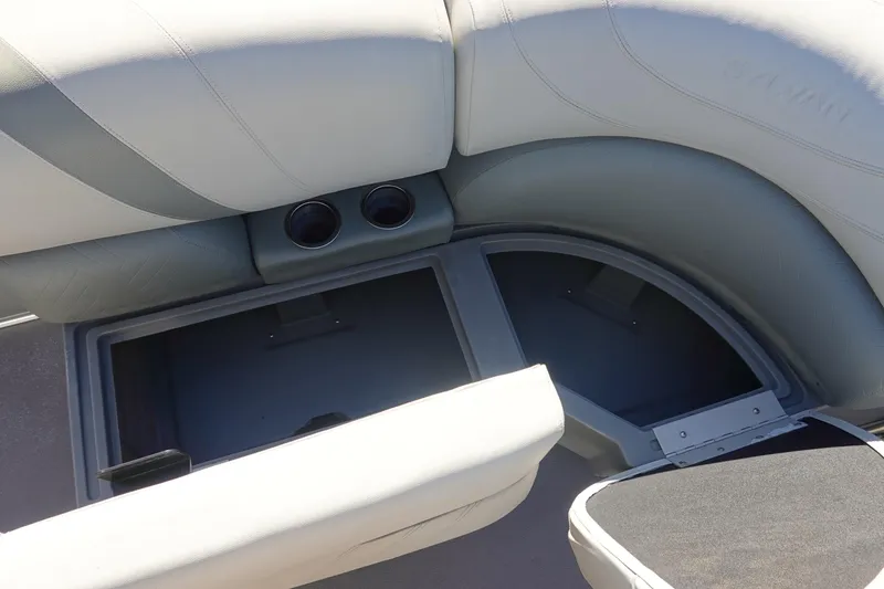 Slide: The Image of 2018 Sylvan Mirage 8522 boat interior with storage compartment and cup holders. - 17