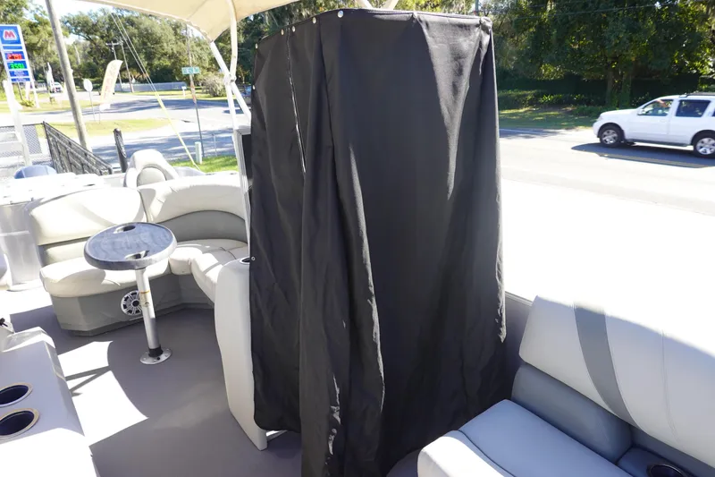 Slide: The Image of 2018 Sylvan Mirage 8522 boat interior with seating and privacy curtain. - 22