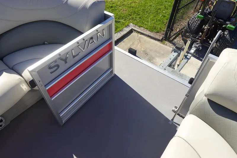 Slide: The Image of 2018 Sylvan Mirage 8522 boat interior with seating and open gate. - 24
