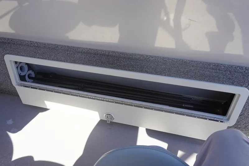 Slide: The Image of Storage compartment in 2018 Sylvan Mirage 8522 boat, featuring secure lock and organized interior. - 26