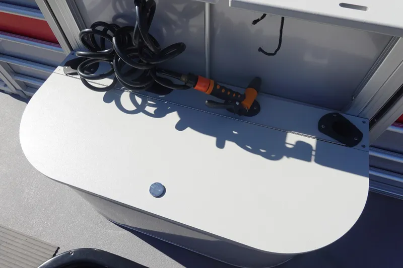 Slide: The Image of 2018 Sylvan Mirage 8522 boat deck with coiled cable and tool. - 27