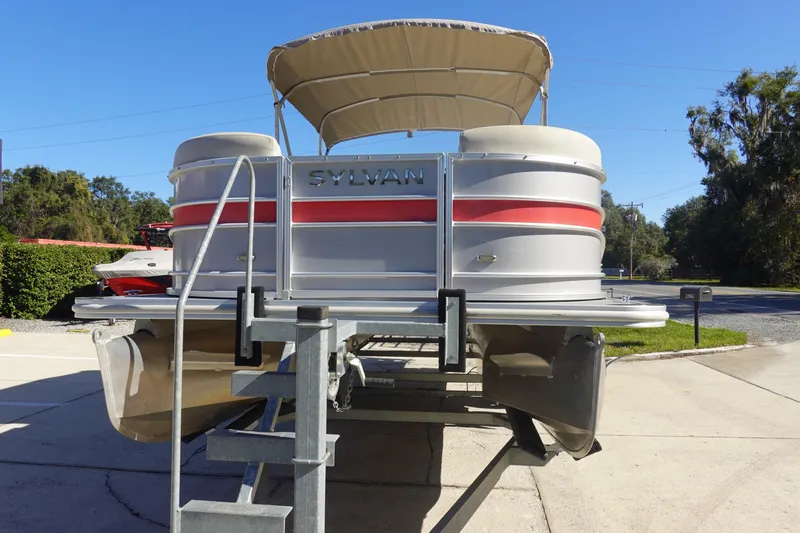 Slide: The Image of 2018 Sylvan Mirage 8522 pontoon boat on trailer, sunny day, outdoor setting. - 3