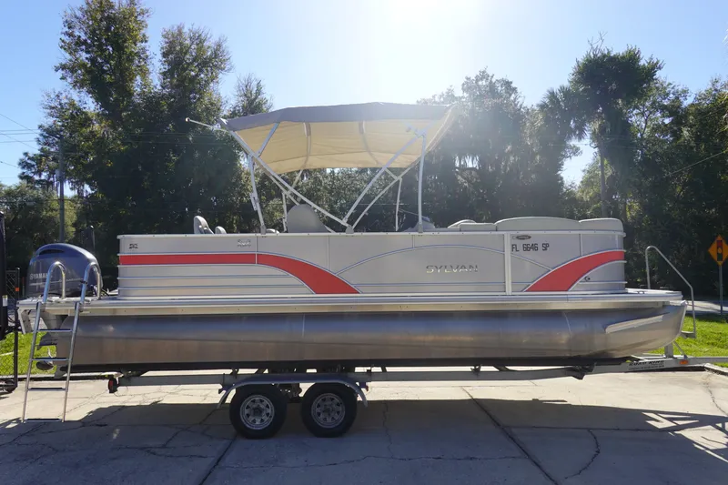 Slide: The Image of 2018 Sylvan Mirage 8522 pontoon boat on trailer, parked outdoors. - 4