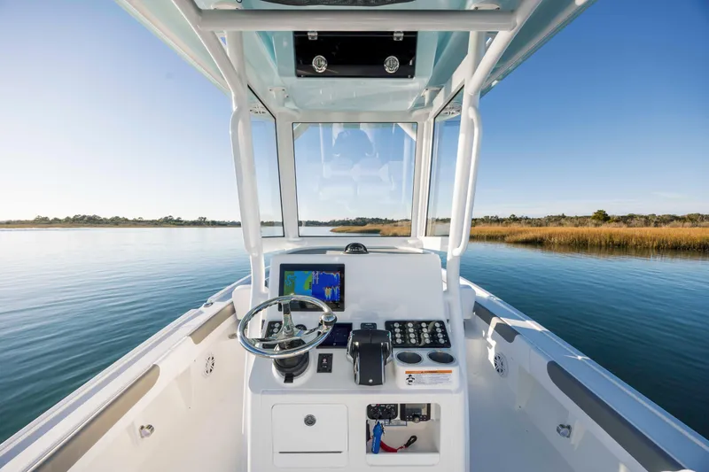 Slide: The Image of Interior view of 2026 Caymas 281 HB on calm water. - 15