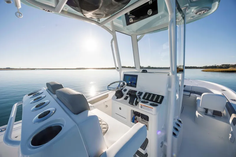 Slide: The Image of Interior view of 2026 Caymas 281 HB boat on calm water. - 20