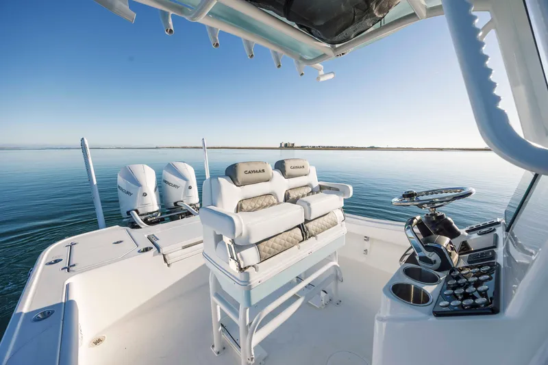 Slide: The Image of Caymas 281 HB 2026 boat with dual Mercury engines on calm water. - 21