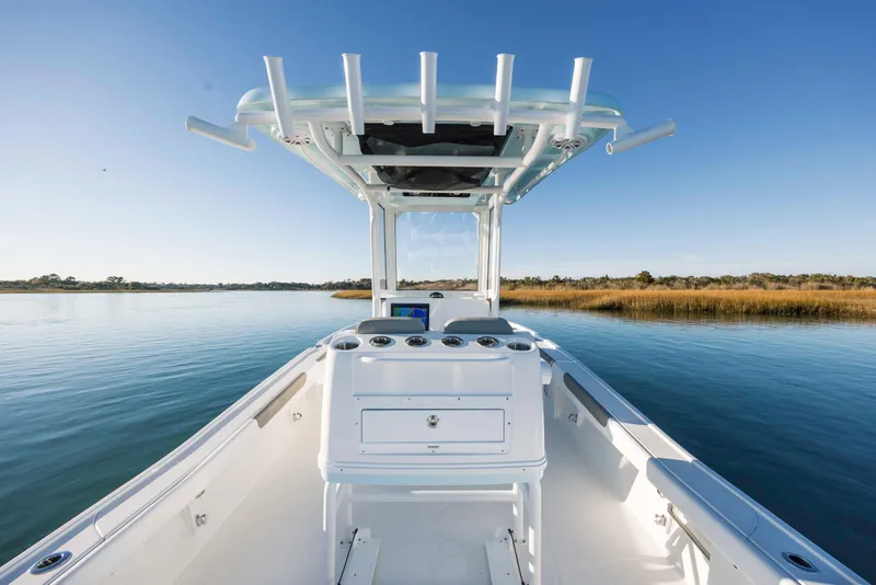 Slide: The Image of Caymas 281 HB 2026 boat on calm water under clear sky. - 22