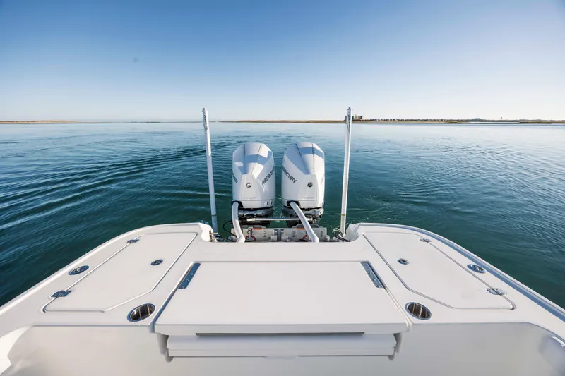 Slide: The Image of Caymas 281 HB 2026 boat with twin outboard engines on calm water. - 25