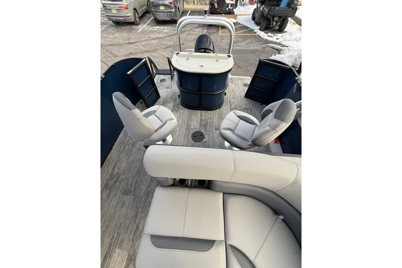 Slide: The Image of 2026 Bentley Pontoons 200 Fish-N-Cruise interior with seating and helm, parked on snowy ground. - 11