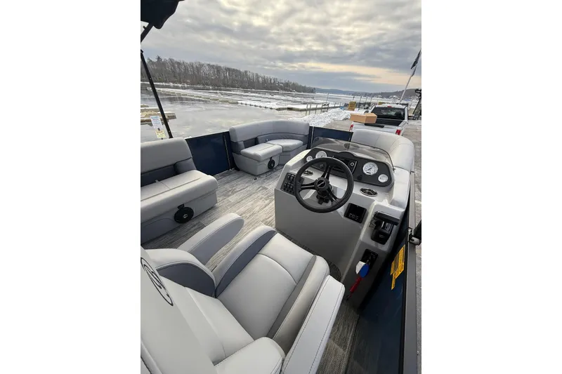 Slide: The Image of 2026 Bentley Pontoons 200 Fish-N-Cruise interior with steering console and seating, dockside view. - 15